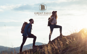 Silhouettes of friends holding hands stands at sunset representing community and solidarity.